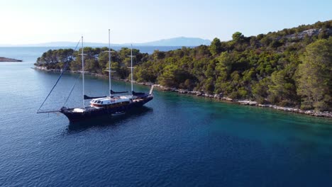 aerial view above a yacht tied to shore in miljet island croatia