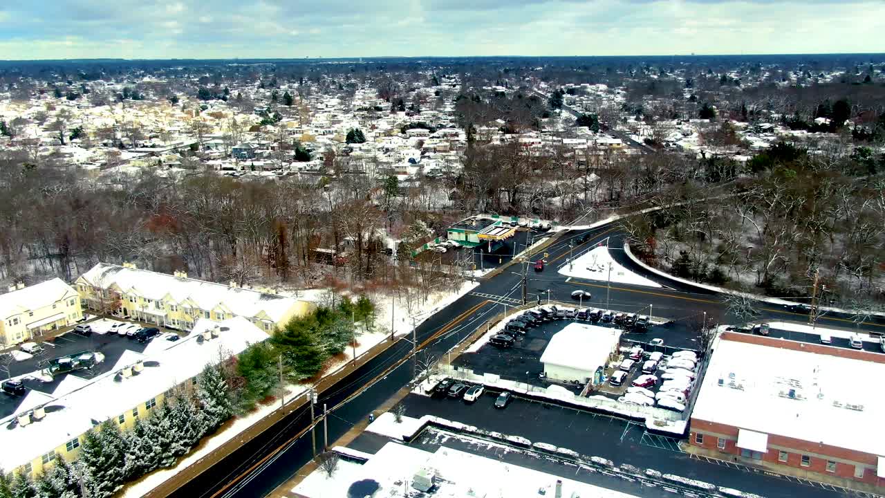 American township covered in Snow, aerial orbit view
