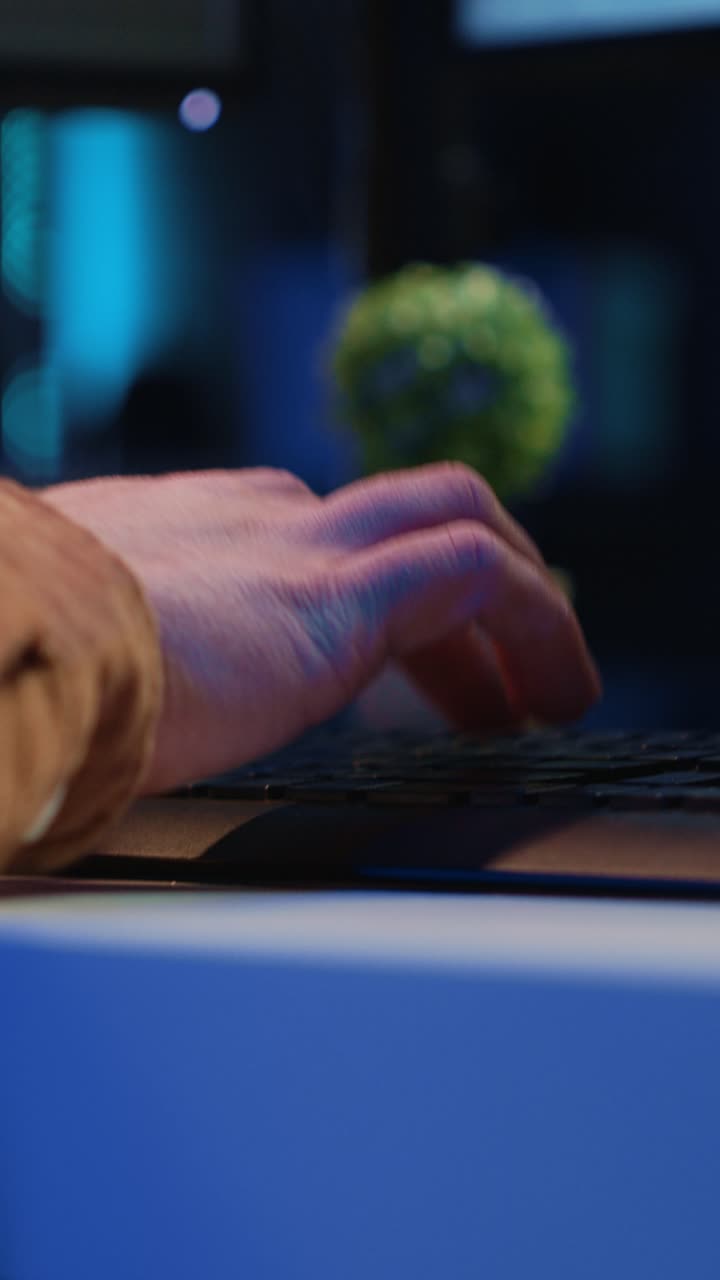 Close-up of Hand Typing Code on Computer at Night