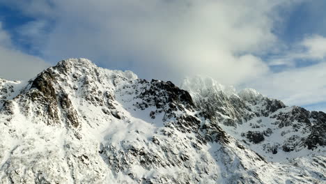 flying toward snowy mountains of lofoten islands in norway