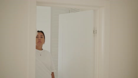 a beautiful pregnant woman tidying her home, engaged in household chores. the scene captures domestic life, maternity, and the balance of routine and preparation during pregnancy