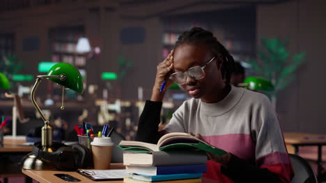 vertical video exhausted student falling asleep while she reads for periodical exams