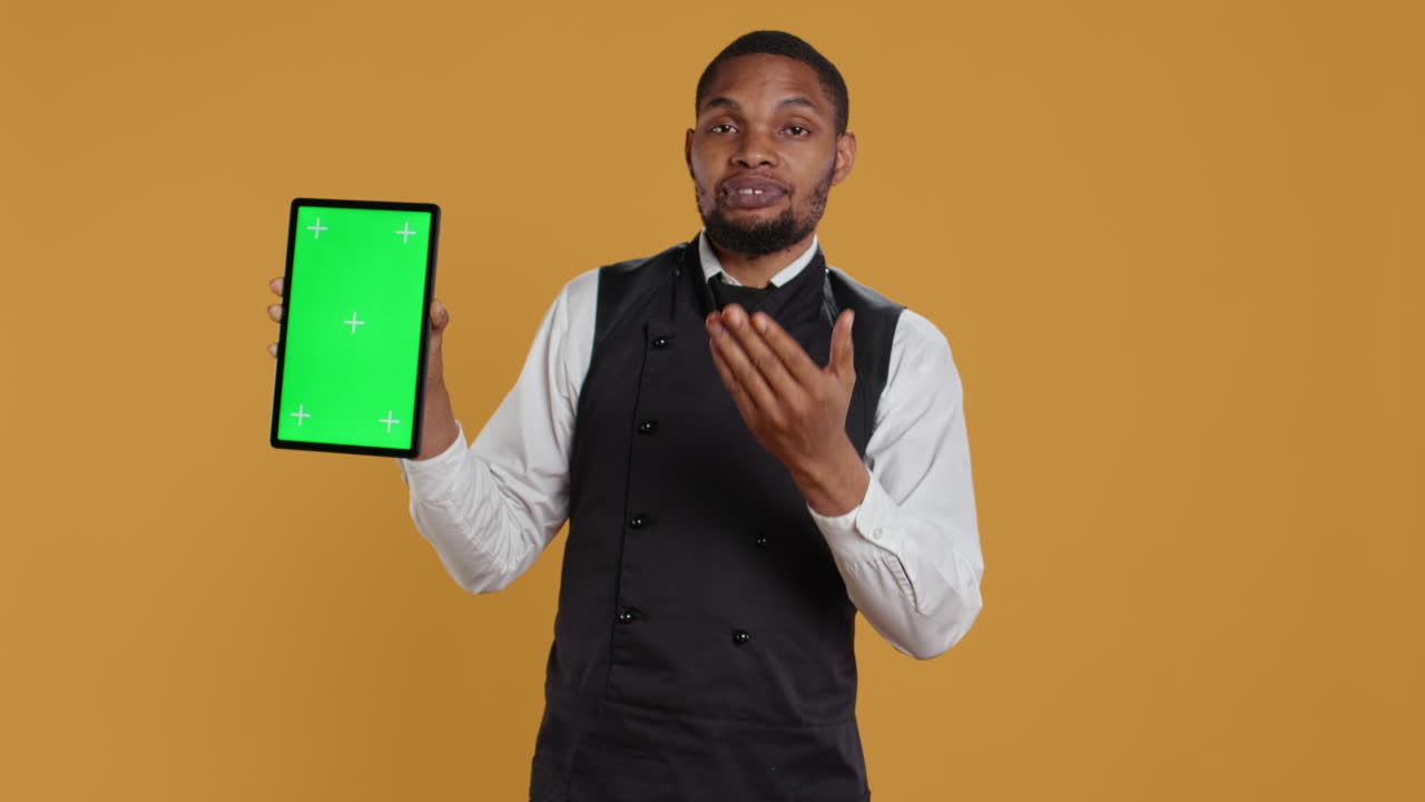 camarero mostrando una tableta con espacio de copia aislado en el estudio