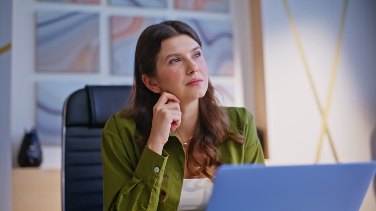 Business woman in office talking on laptop