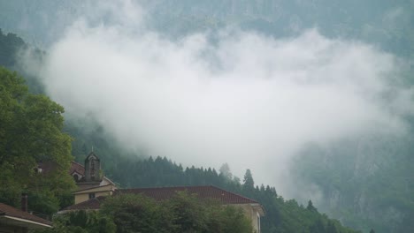 foggy morning in konitsa a traditional village in epirus region in greece day shot  creepy cinematic mood green leaf on front
