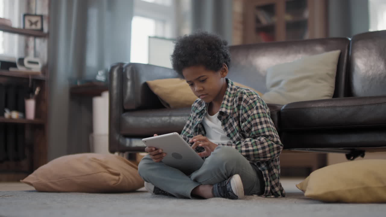 Afro Boy Using Tablet At Home