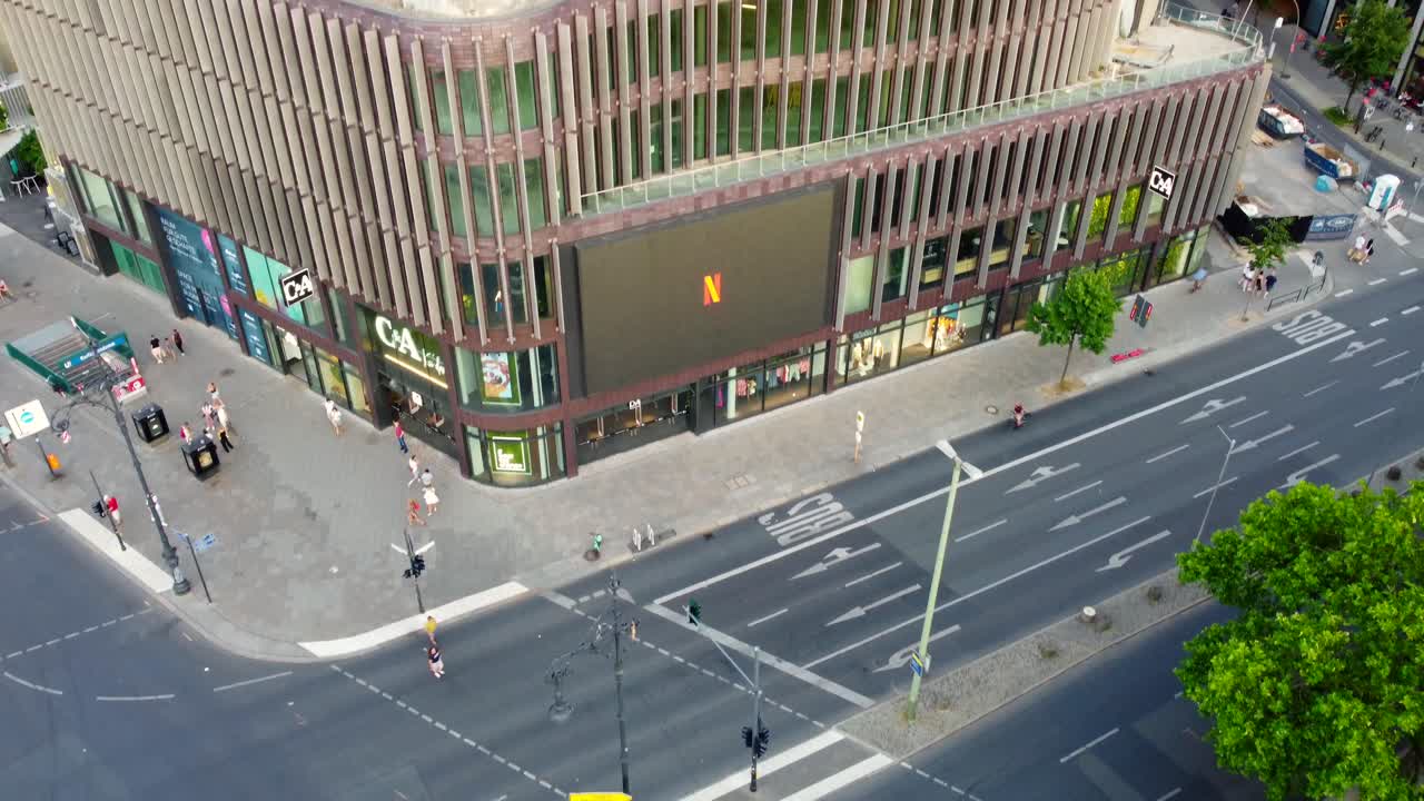 Large LED screen as advertising panel on building Beautiful aerial view flight pedestal down drone of Kurfürstendamm Berlin germany at summer day sunset July 2022. Marnitz 4k Cinematic from above