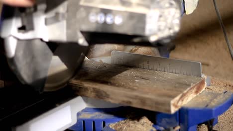 mitre saw sawing wood with power tool in a factory stock footage