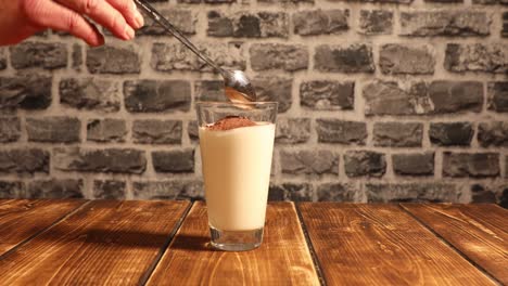 pouring a glass of milk and mixing cocoa powder with a mixer