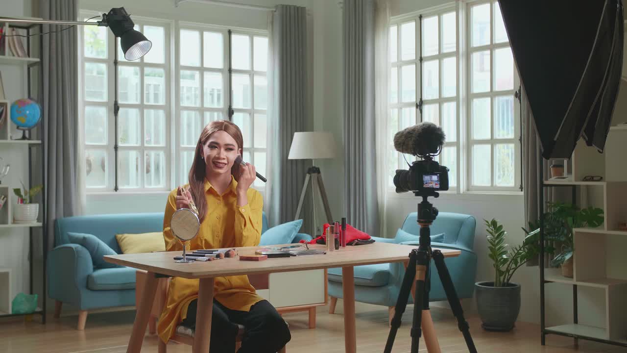 Influencer Young Transgender Woman Blogger Talks About Makeup. Transgender Woman Recording Video Blog Tells How To Be Beautiful. Blogger Talks Facial Beauty Treatments. Vlogger Broadcasts How To Use Of Cosmetic In Home Studio With Professional Lighting Equipment