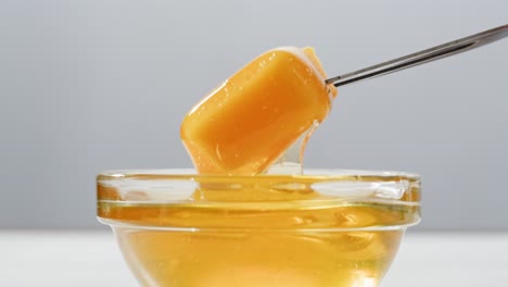 honey dipping in glass bowl