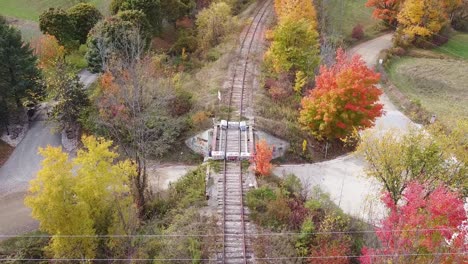 railway bridge over road in rural area of caledon during autumn