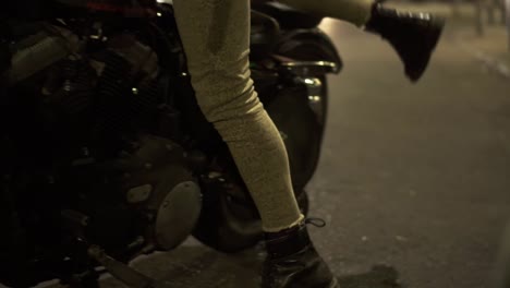 footage of a handsome rider walks to his motobike, starting to the street night traffic