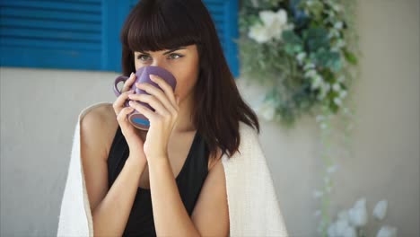 woman enjoying a drink on a patio