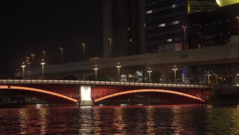 view of 463 road bridge lit up be red neon lighting over sumida river in tokyo