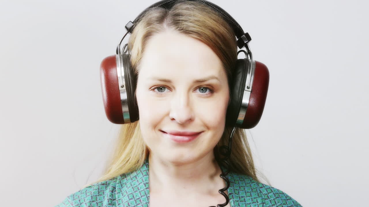 cool female dancer with changing retro headphones to listen to music