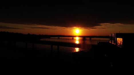 Aerial-view-of-a-sunset-above-the-bridges-between-Lauttasaari-and-Ruoholahti,-in-Helsinki