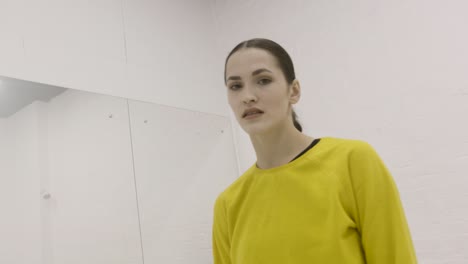 woman in a yellow shirt in a modern dance studio