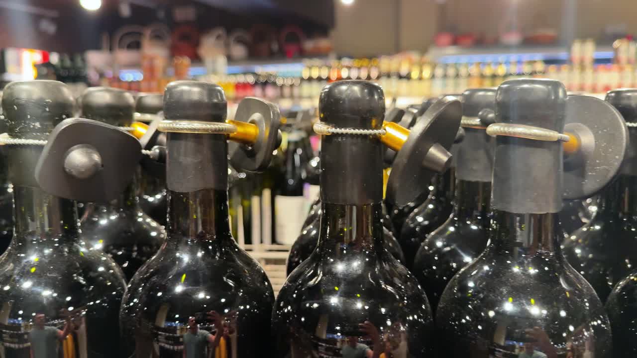 Rows of Wine Bottles with Security Tags in a Store