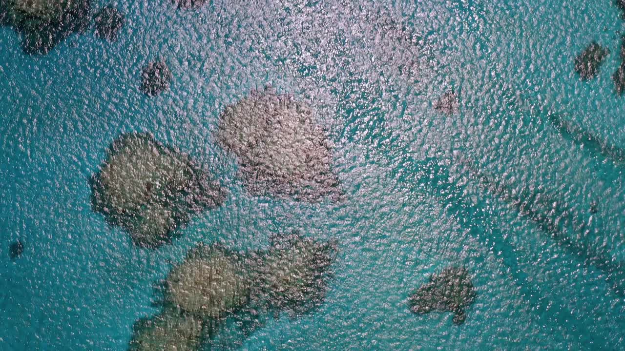 Aerial fly-over of clear blue ocean water in Tonga