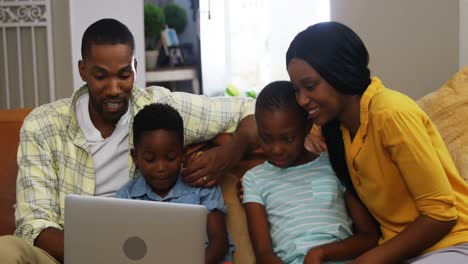 family using laptop in living room 4k