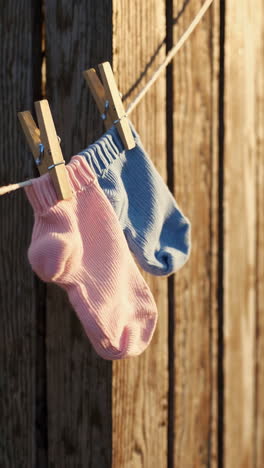 pink and blue socks drying on a clothesline