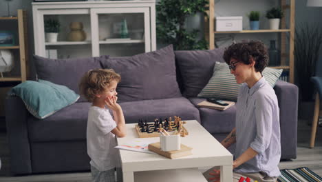 mother and child playing chess