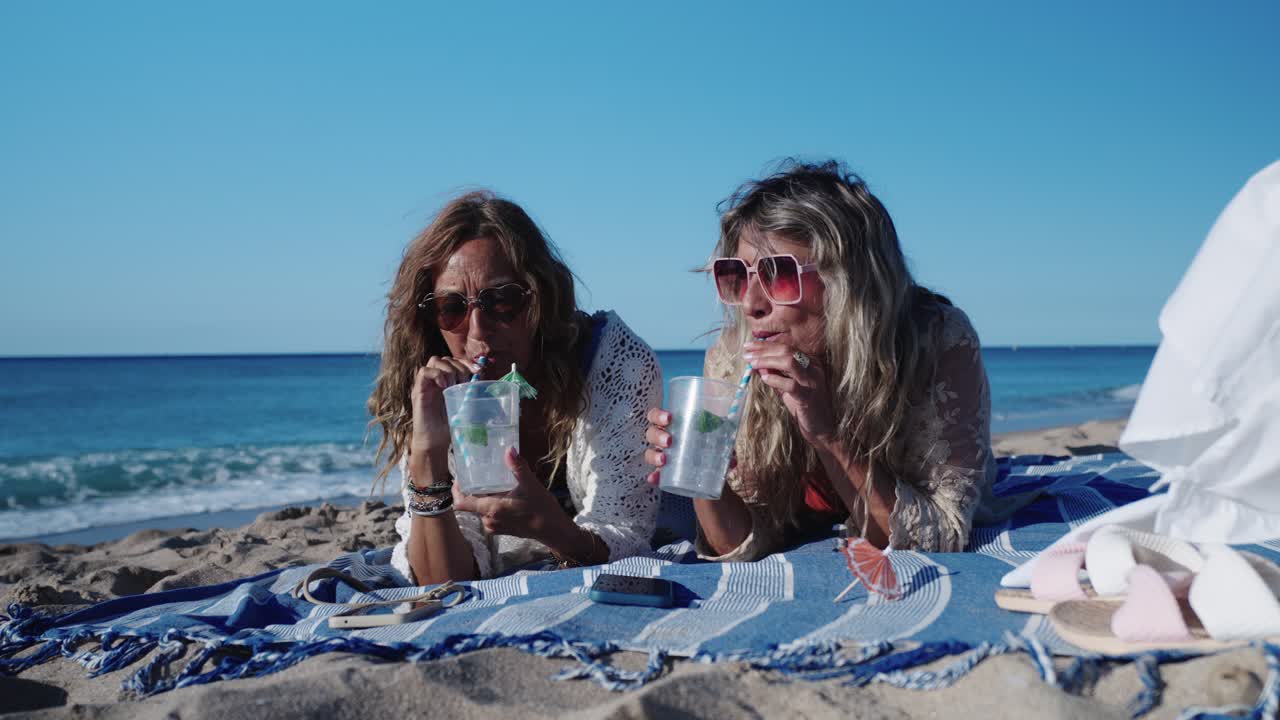 Women Enjoying Drinks on the Beach