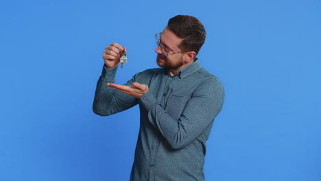 caucasian man real estate agent showing keys of new home house apartment buying renting property