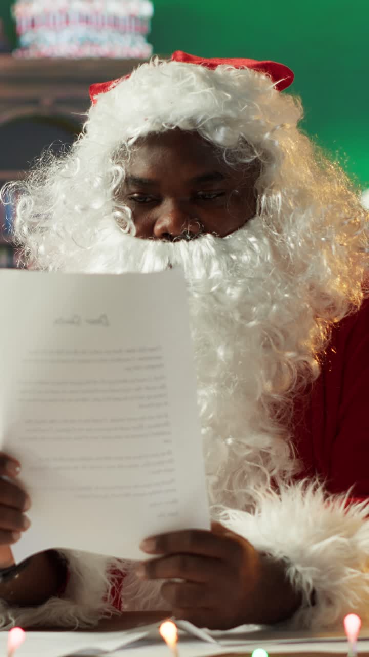 Happy African American Santa Claus Reading a Christmas Letter
