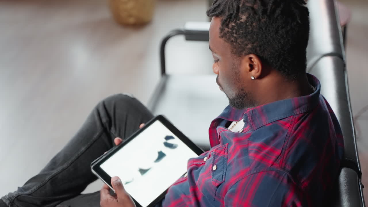 Man shopping for shoes online on tablet