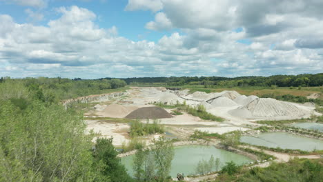 Daylight-Aerial-Flyover-of-Wide-Shot-Limestone-Quarry-in-Operation