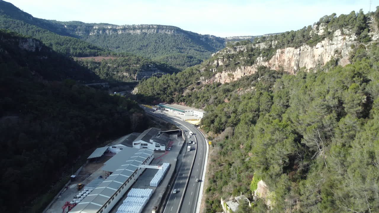 Aerial View of a Mountain Valley Road and Industrial Buildings