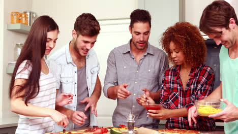 Smiling-friends-making-pizza-together