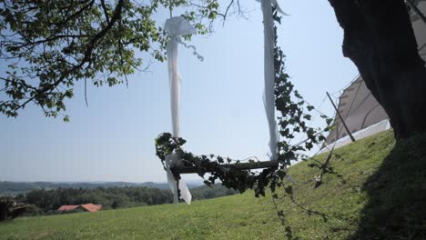 swing hanging from tree as wedding decoration on sunny day, wide dolly forward