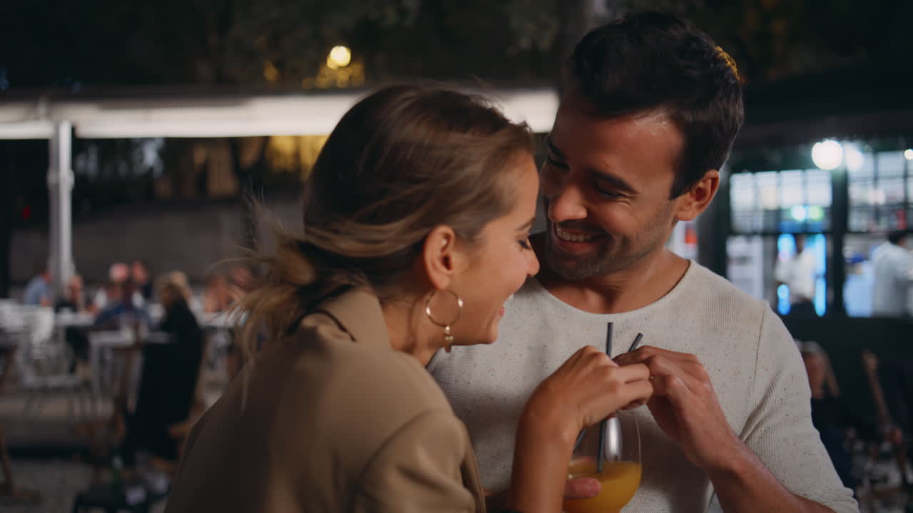 Happy pair tasting alcohol having fun on date closeup. Romantic partners drink