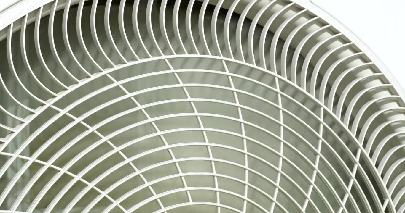 Detailed close up of an air conditioner grille showcasing its intricate metal mesh design.