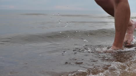 the man was walking along the sea shore, his face could not be seen