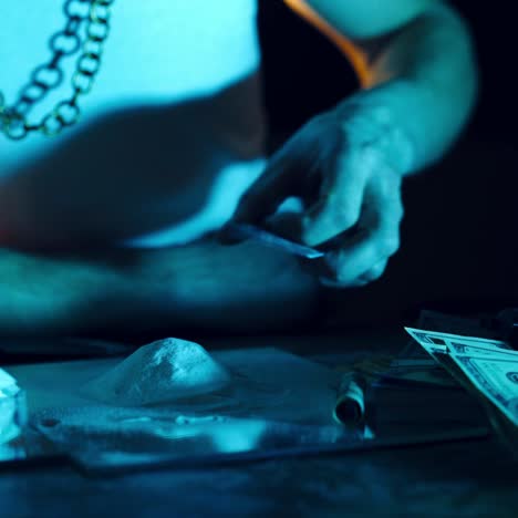 Drug addict preparing cocaine lines. Cocaine powder sorted. Concept of drug abuse. Social problems