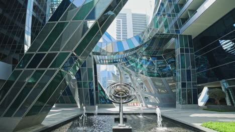 modern architectural complex with fountain and sculpture
