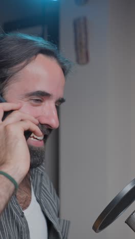 man on a phone call in a recording studio