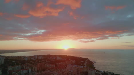 aerial sun rising ocean horizon. golden sunrise illuminating cozy harbor town