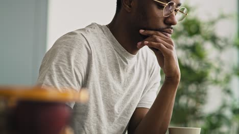 Tilt-down-video-of-black-man-typing-on-a-laptop-keyboard