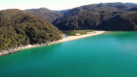 Sandfly-Bay-aerial-fly-forward-to-the-beach-crossing-the-sea-shot