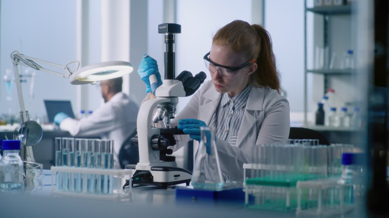 Female scientist working with a microscope in a modern laboratory
