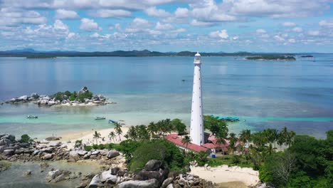 wide aerial of rocky beach on lengkuas island in belitung on sunny summer day