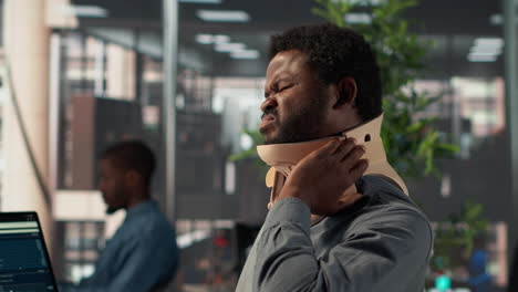 man with neck brace in office