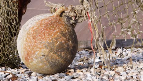 a sphere at a port and ropes hanging in the wind