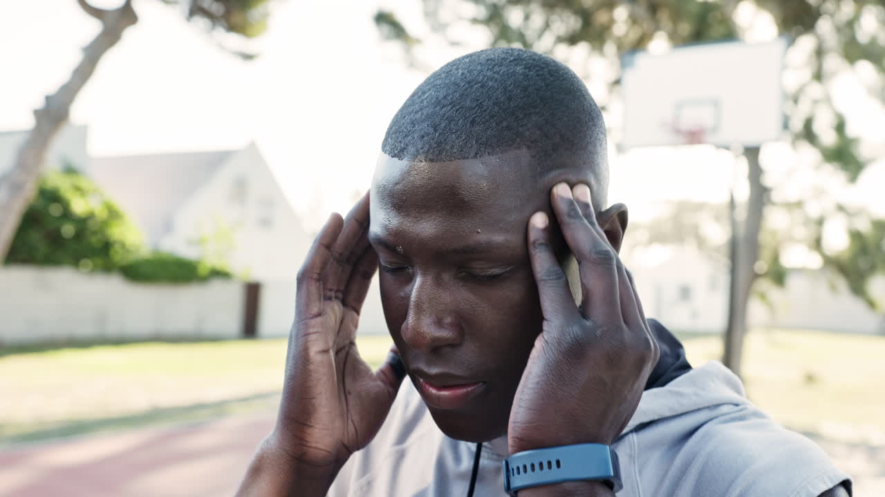 Man experiencing headache outdoors