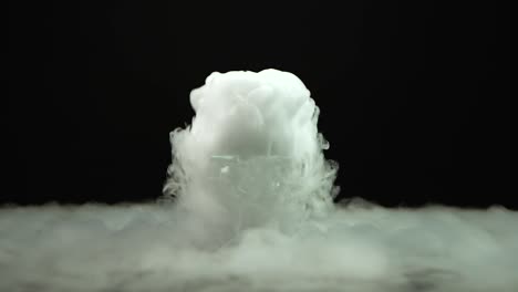 cognac glass with the effect of white dry ice at black background